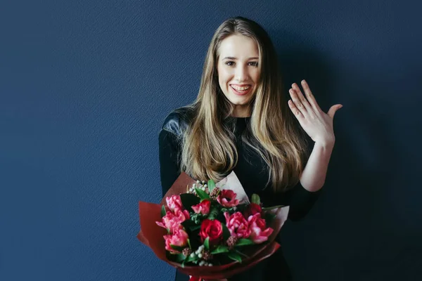 Schattig meisje met boeket van rode tulpen. — Stockfoto