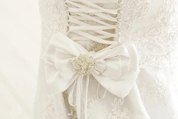 A close up of a wedding dress with a large silk bow — Stock Photo, Image
