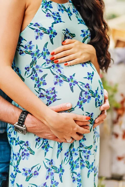 Close-up of human hands holding pregnant belly — Stock Photo, Image