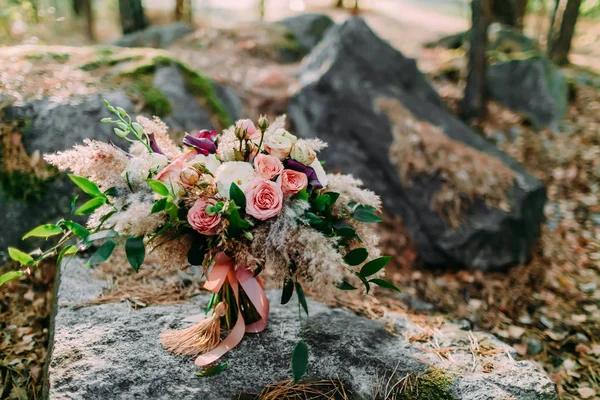 Schöner Hochzeitsstrauß, der auf einem Stein im Park liegt. Herbsthochzeit — Stockfoto