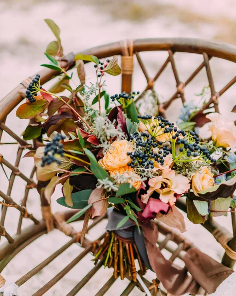 Gorgeous wedding bouquet consisting of different flowers lying on a ground in the park. Bunch of flowers — Stock Photo, Image