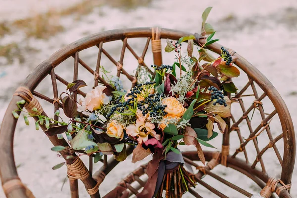 Beautiful bridal bouquet consisting of different flowers lying on a ground in the park. Bunch of flowers — Stock Photo, Image