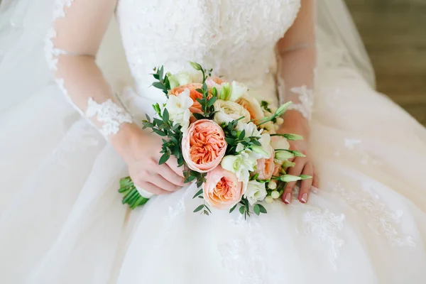 Przepiękny bukiet kwiatów biały i pomarańczowy w rękach uroczy czekać w białej sukni. — Zdjęcie stockowe