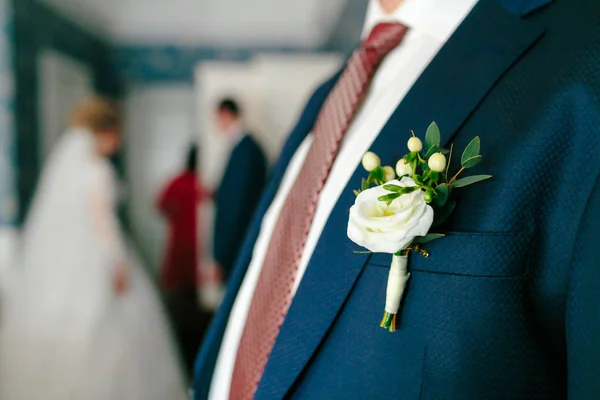 Boutonniere blanco sujetado a una chaqueta de novio. Preparación de boda — Foto de Stock