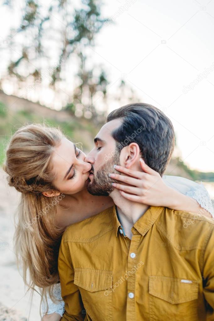 A young couple is kissing. Close-up portrait