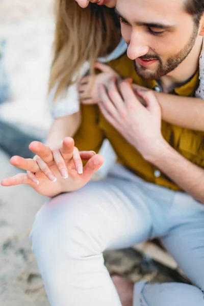 A couple are holding hands on the beach. Closeup. Top view — Stock Photo, Image