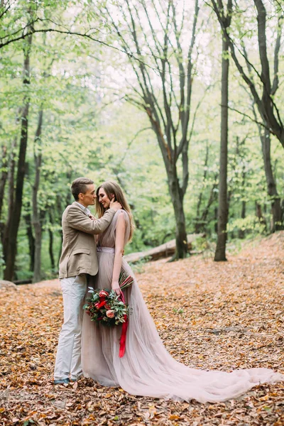 Noiva e noivo está andando em uma trilha em um belo lugar romântico na natureza. Cerimônia de casamento ao ar livre . — Fotografia de Stock