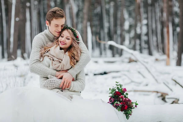 Bride and groom are hugging in the winter forest. Close-up. Winter wedding ceremony. — Stock Photo, Image