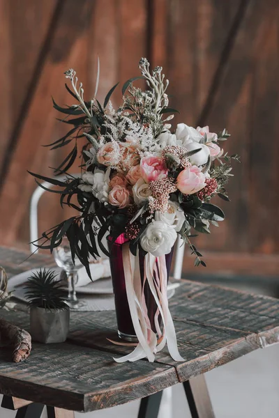 Buquê de casamento com rosas brancas e rosa e outras flores em uma mesa rústica. Obra. Interior . — Fotografia de Stock