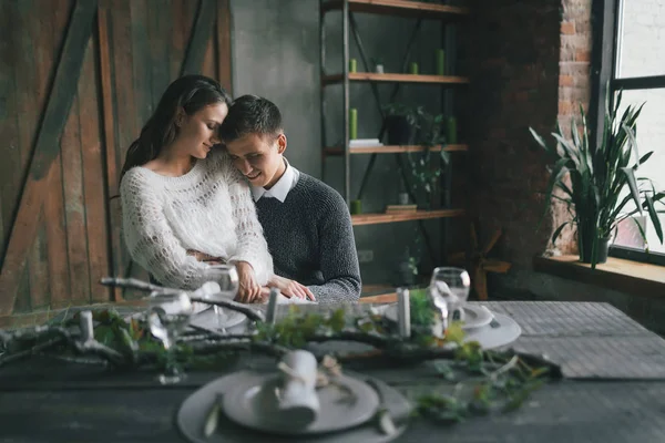 A cute couple sits in the kitchen and hugs. — Stock Photo, Image