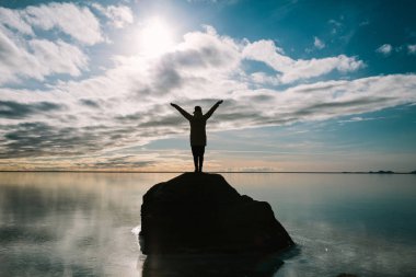 Yolculuğun tadını, aramaktan ve ellerini havaya kaldırmış genç mutlu bir kadın görünümünü arka. Seyahat İzlanda.