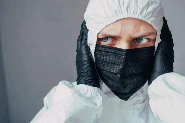 Nurse Black Mask Viral Protective Suit Holds Her Head Looks — Stock Photo, Image