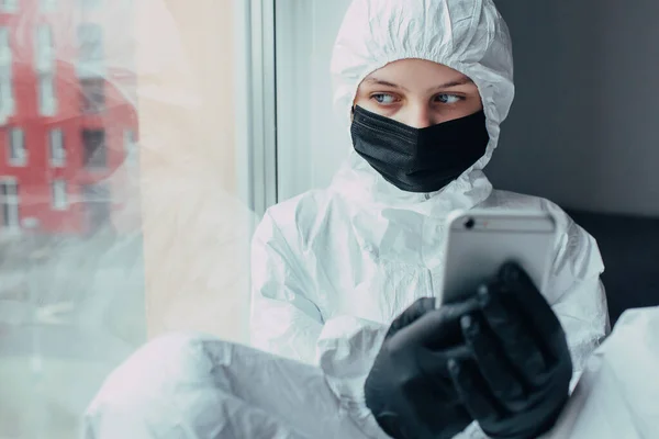 Teenager Black Mask Viral Protective Suit Medical Gloves Holds Phone — Stock Photo, Image