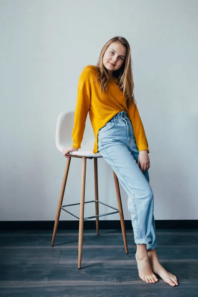 Teenage Girl Looks Camera Standing Lean White Modern Chair Beautiful Stock Image