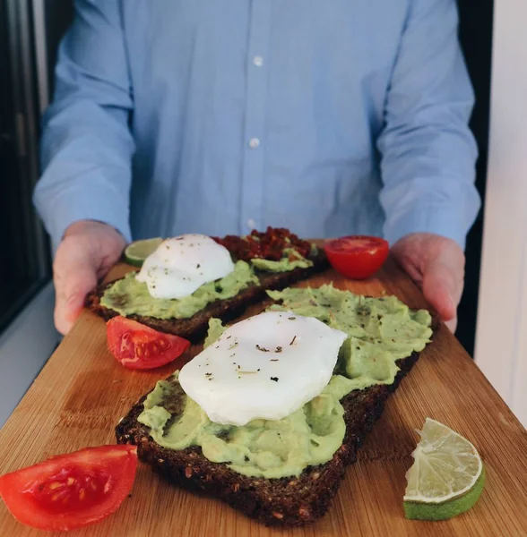 Cropped View Man Presenting Sandwiches Mashed Avocado Poached Eggs Lime — Stock Photo, Image