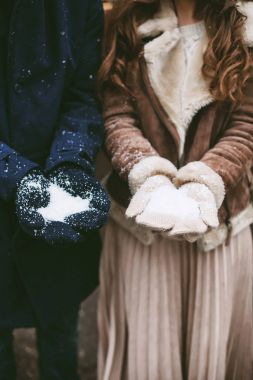 Young happy couple holding snow clipart