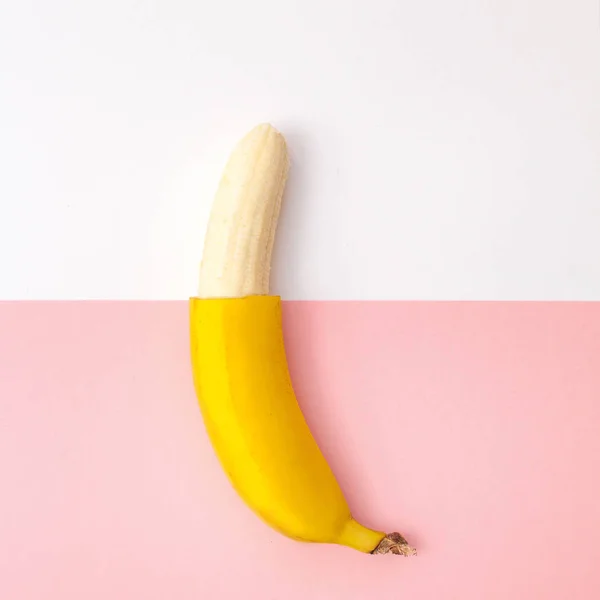 Strato piatto di una banana mezza sbucciata — Foto Stock