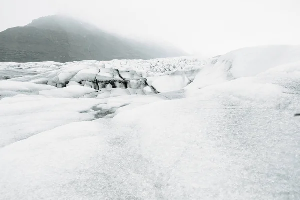 Glacier of Skaftafell National Park and people walking on it, Iceland