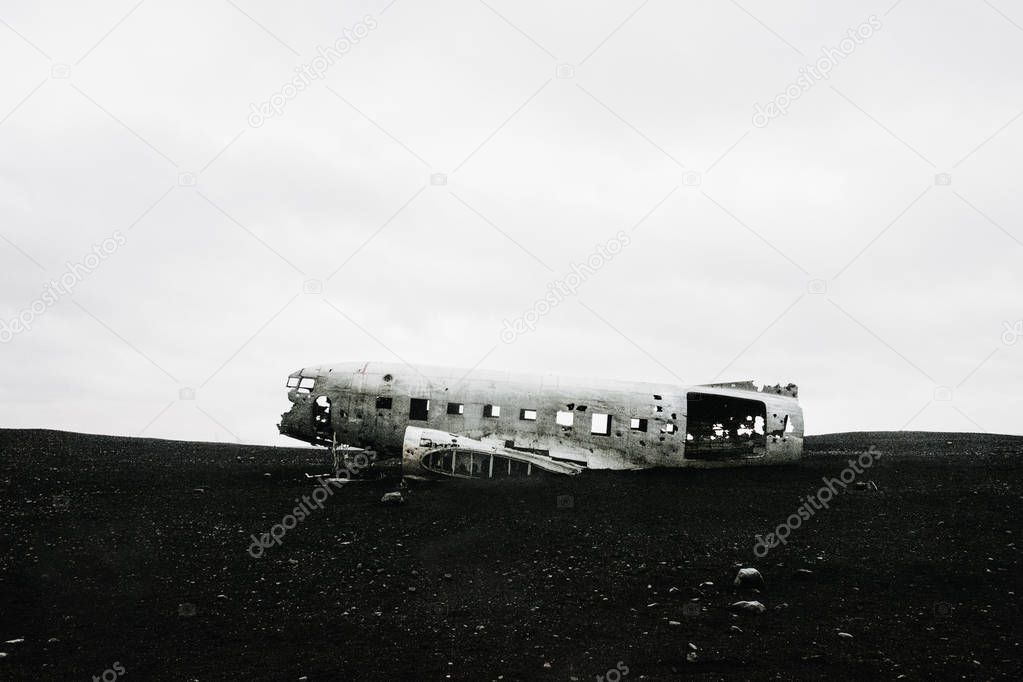The famous wrecked abandoned Dc-3 airplane on a black sand beach in Iceland 