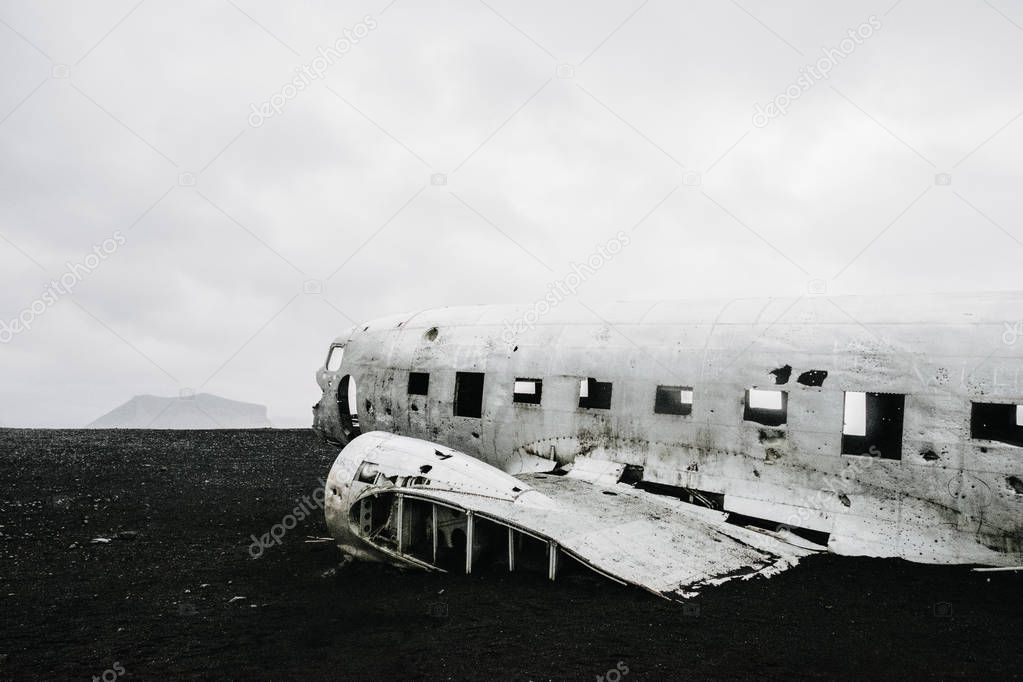 The famous wrecked abandoned Dc-3 airplane on a black sand beach in Iceland 