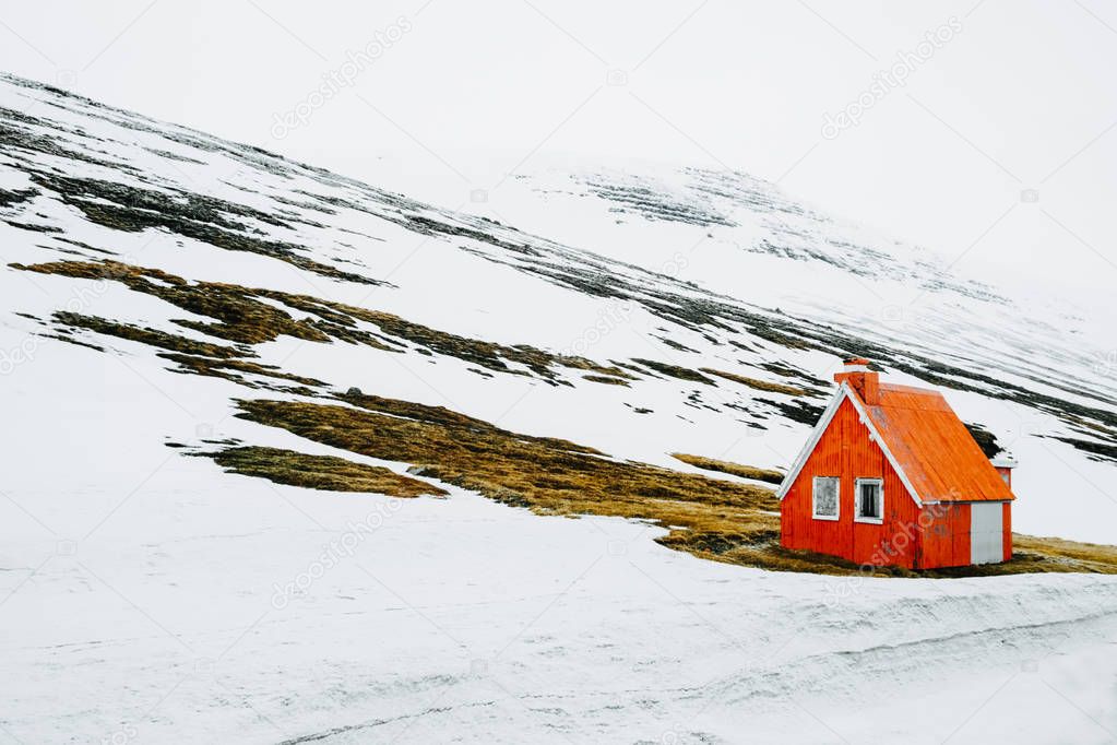 Lonely abandoned wooden house at snowy coastline in West Iceland. Winter northern scenery 