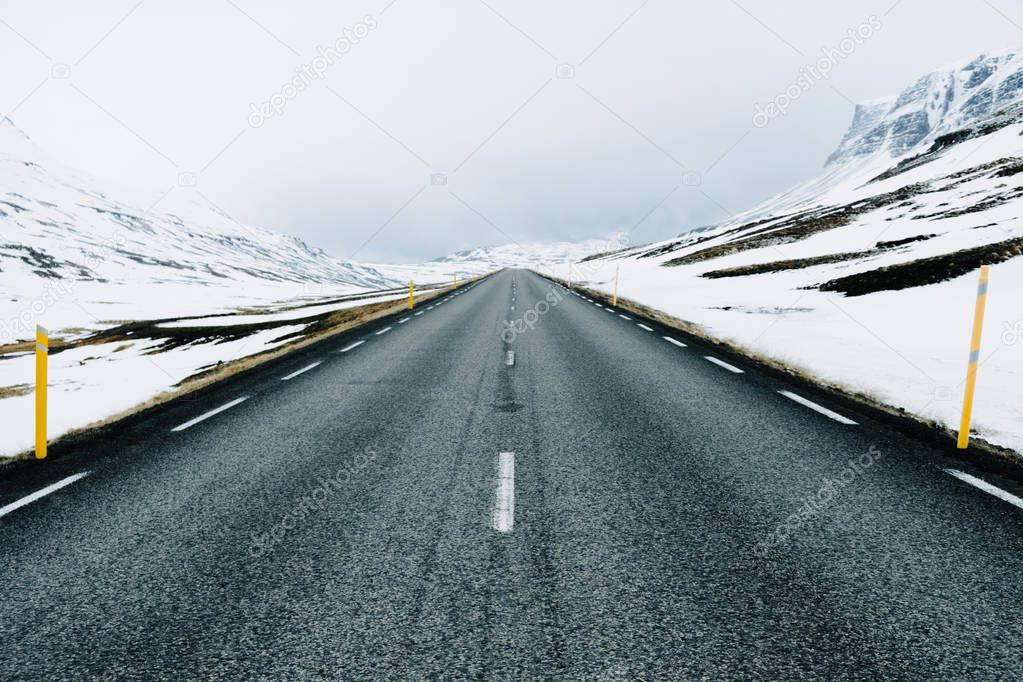 A highway winter  road in rural Iceland. Mountains on the background