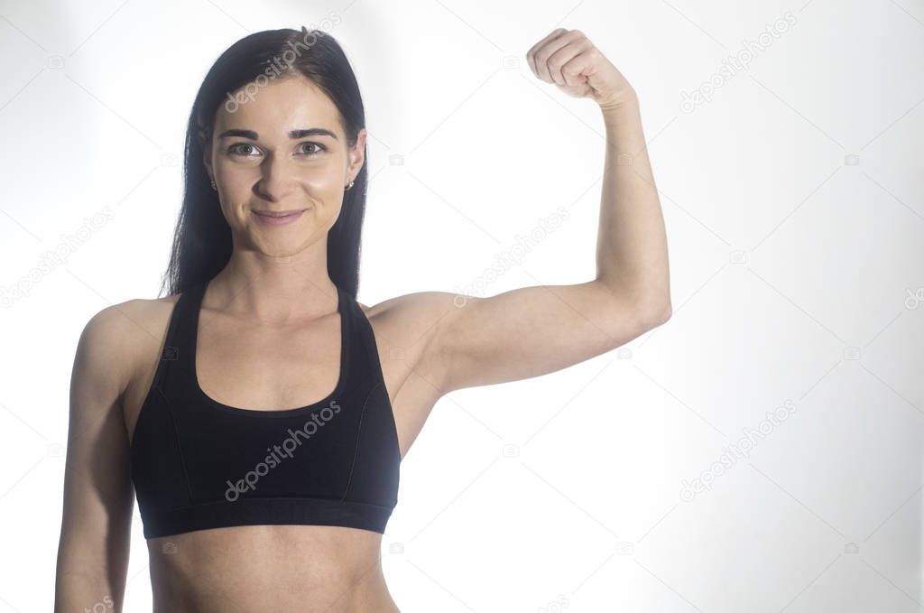 Beautiful girl. The girl shows biceps. 