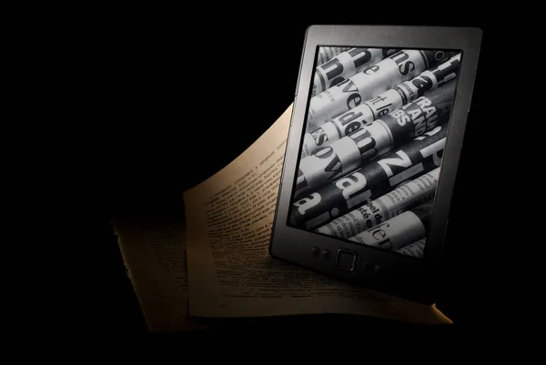 E-book and paper. E-book on a black background. Beautiful photo