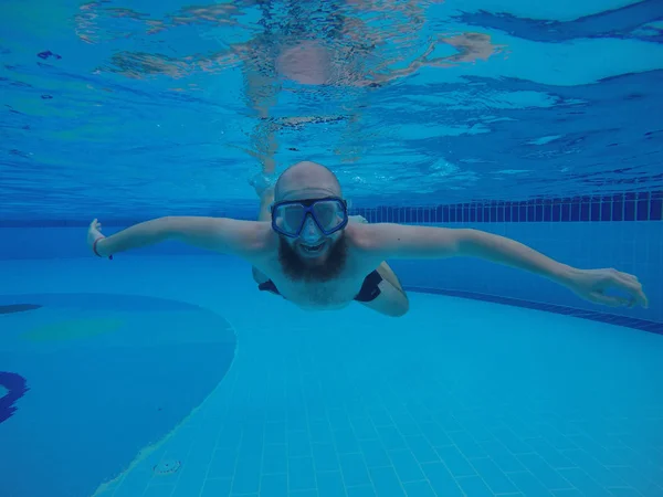 Man with a beard. Bearded man swimming in the pool.