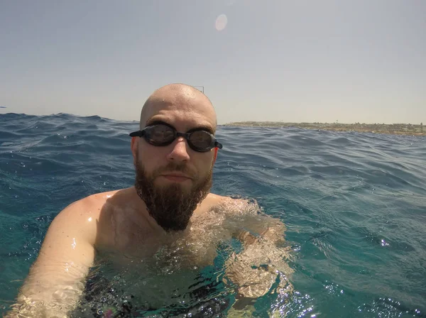 Man with a beard. Bearded man swimming in the red sea.