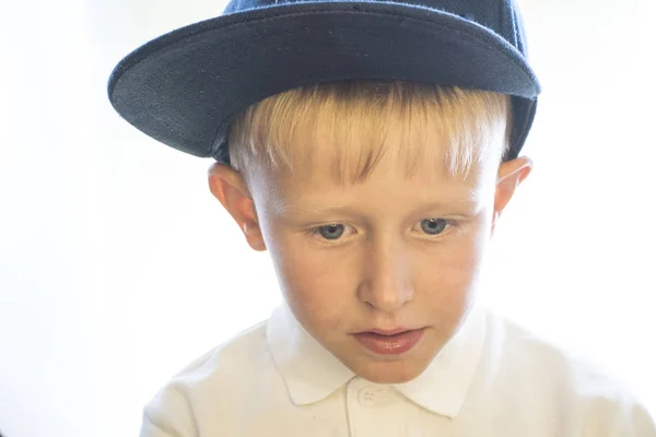 Retrato de un niño pequeño con gorra y camisa blanca . —  Fotos de Stock