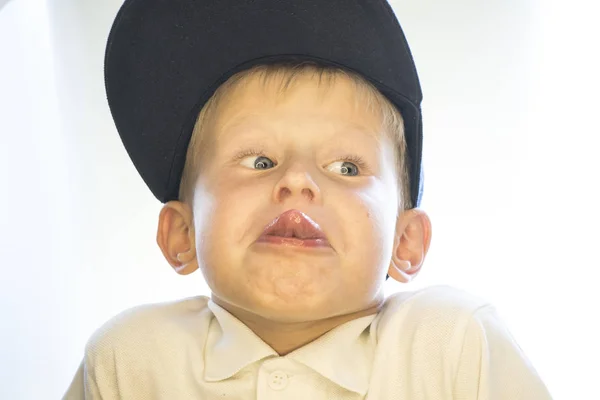 The boy shows the tongue. — Stock Photo, Image