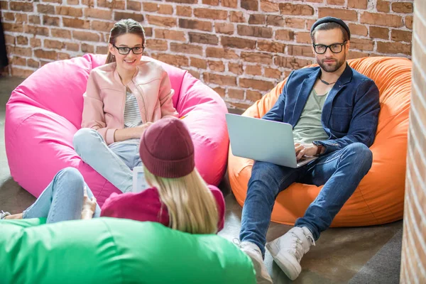 People in bean bag chairs — Stock Photo, Image