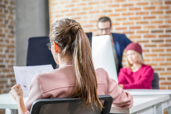 Woman examining blueprint