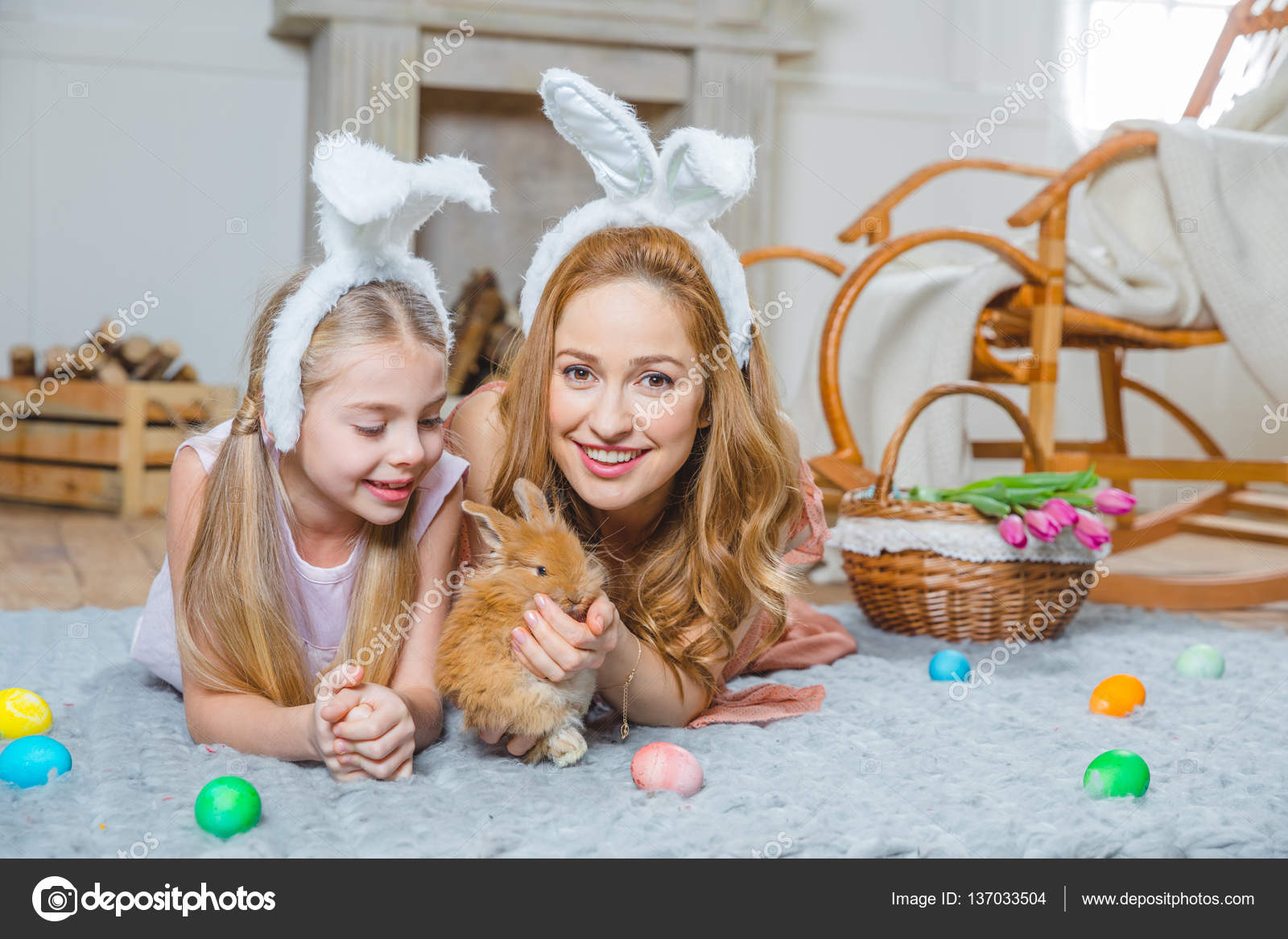 Mother and daughter playing with rabbit — Stock Photo © AndreyBezuglov