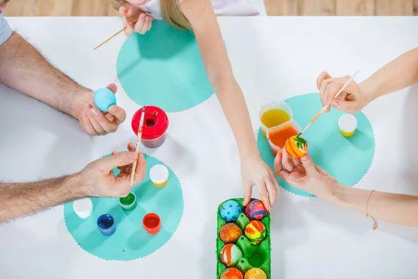 Family painting Easter eggs