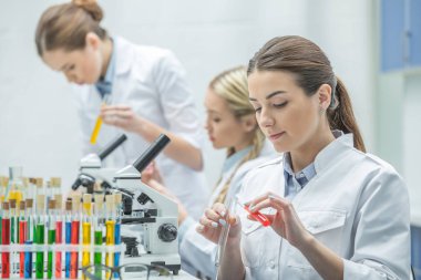 Female scientists in lab clipart