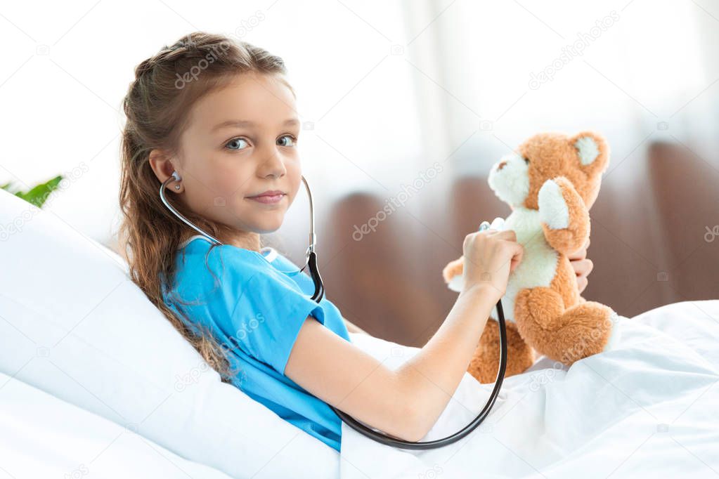 patient with stethoscope and teddy bear