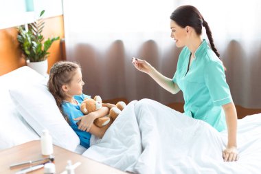 Girl and nurse in hospital clipart