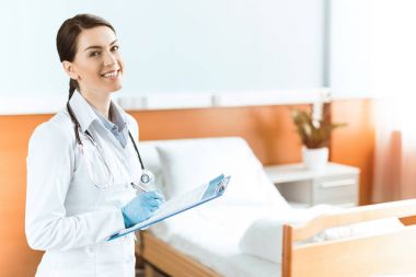 Young woman doctor with clipboard clipart