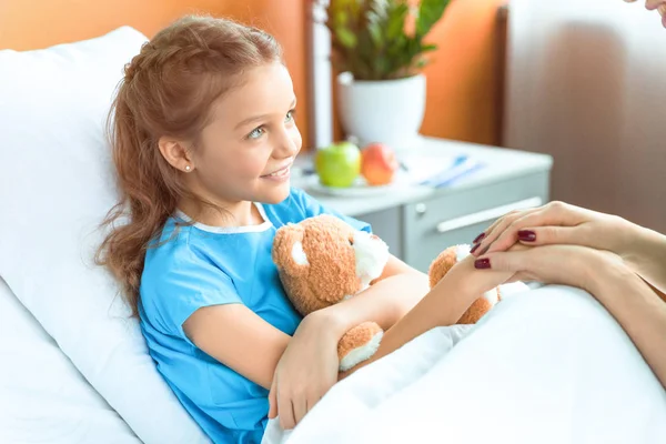 Doctor and patient holding hands — Stock Photo, Image