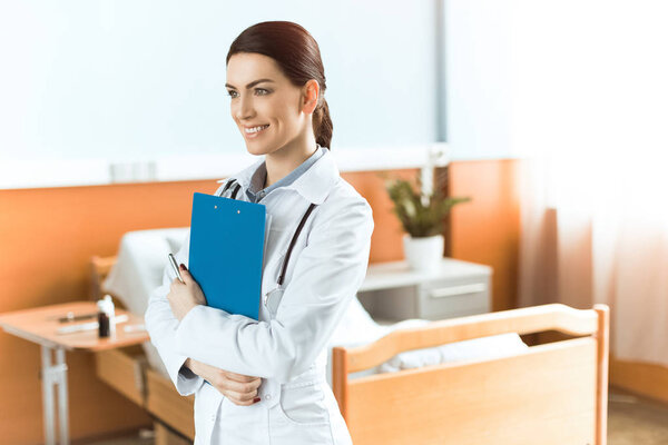 Young woman doctor with clipboard