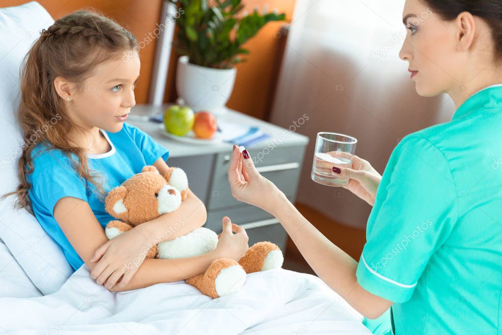 Doctor giving pill to patient 