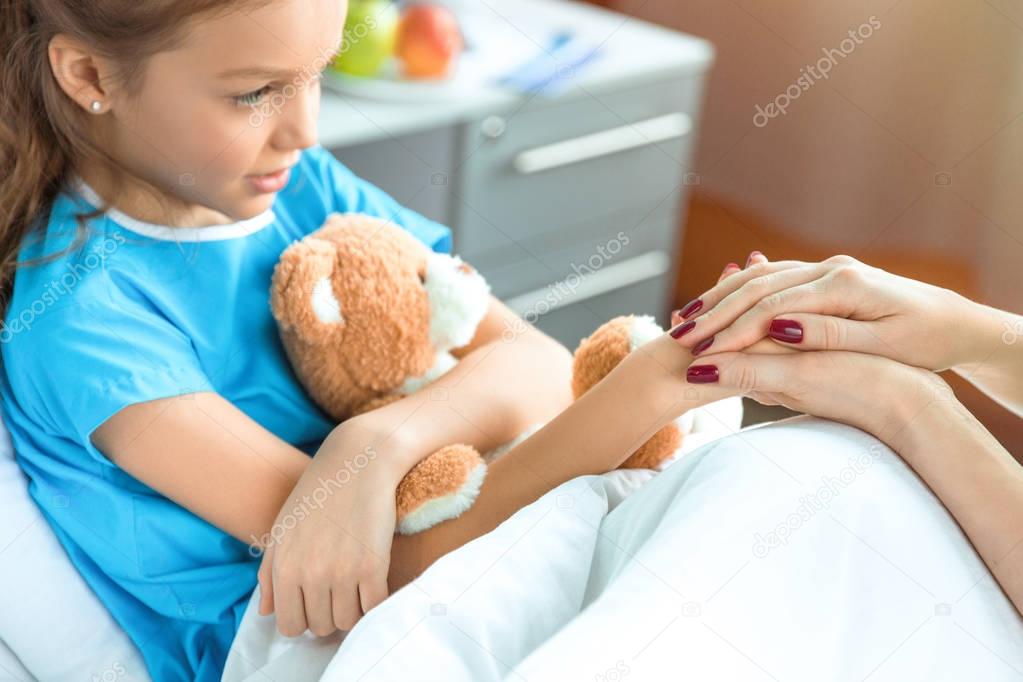 Doctor and patient holding hands