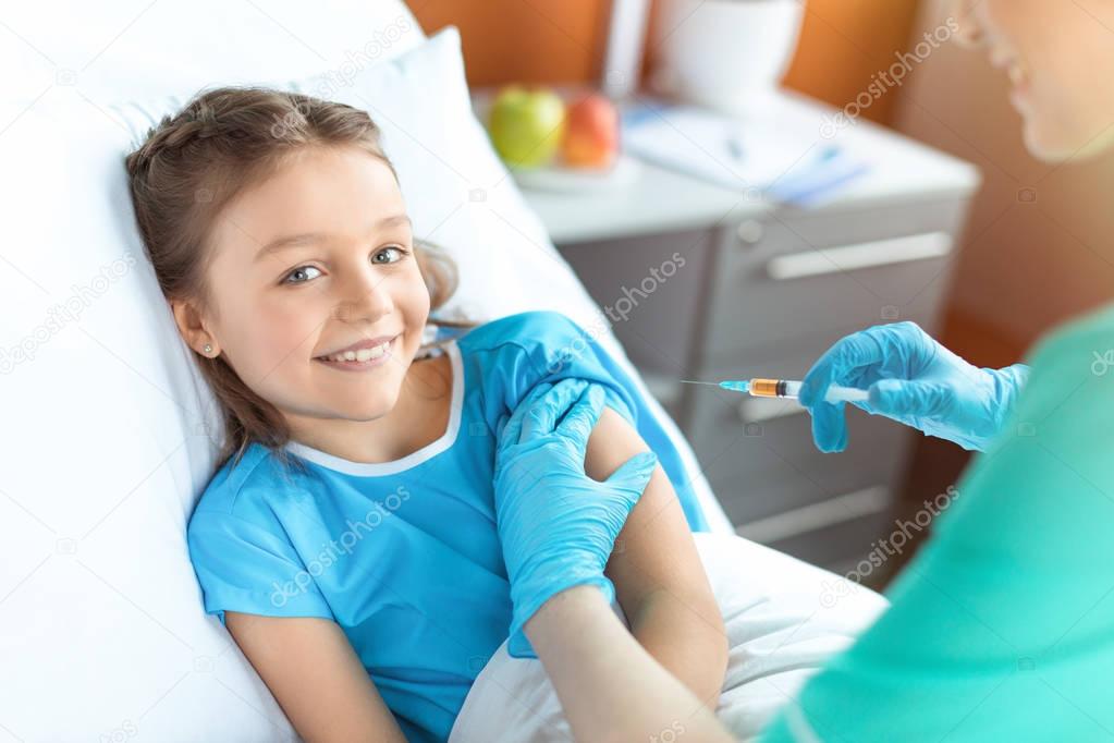 Doctor doing injection to patient 
