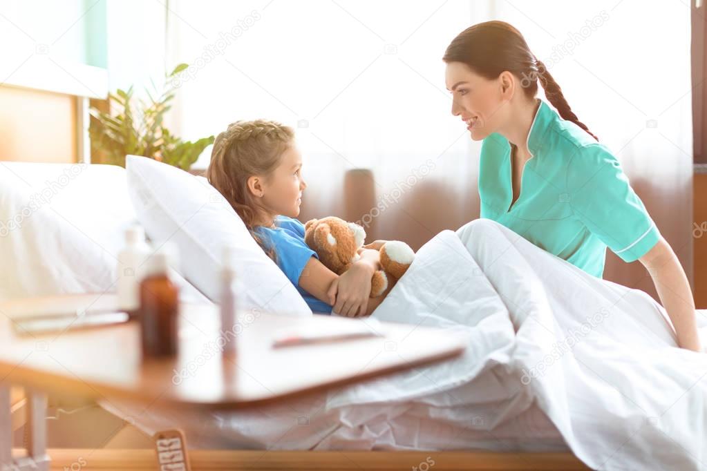 Girl and nurse in hospital