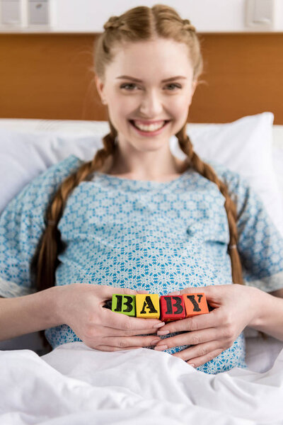 Pregnant woman with baby cubes 