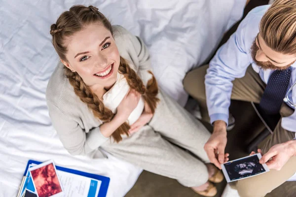 Doctor and woman with ultrasound scans Stock Picture