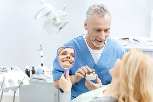 Dentista che mostra modello mascelle — Foto Stock