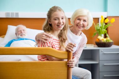 grandmother and granddaughter visiting patient  clipart